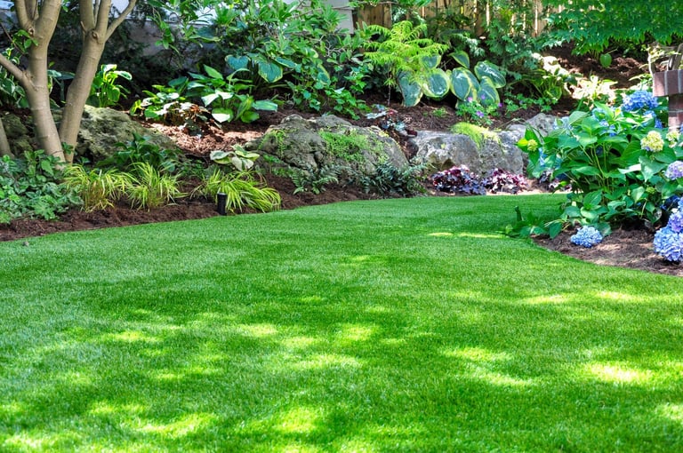 Beautiful backyard woodland garden with artificial grass lawn